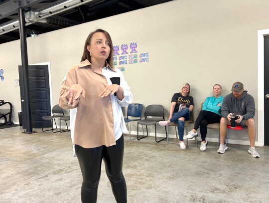 • photo by Mark Codner Elevate Dance Academy owner/teacher Kelsey Britton provides information on the facility and available programs during the Friday Morning Mingle. Her facility was host to the Newcastle Chamber of Commerce event.