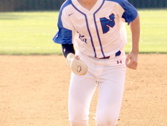 • photo by Lisa Longman Smith Jackson Robertson makes the turn running bases for the Racers.