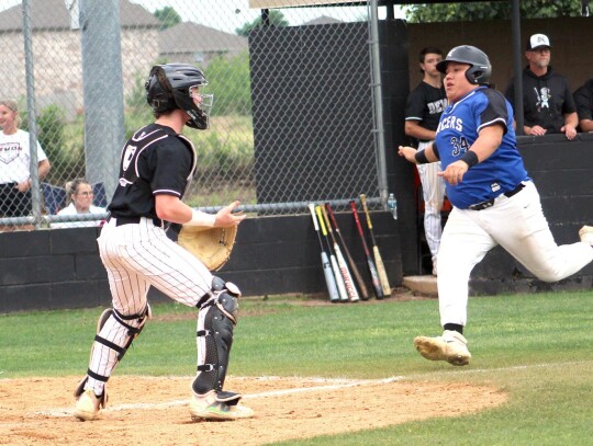 Taj Smith scores a run for the Racers during the Super Regional game against Perkins-Tryon last week to help put Newcastle in the State Playoffs.