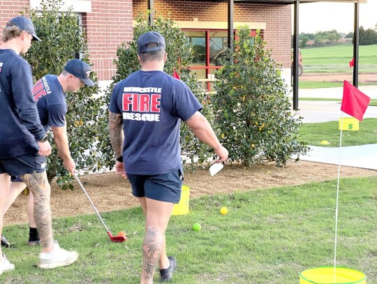 Newcastle firefighters enjoyed a moment of sport between chores at the new Fire Station #1. Their many chores include rolling the hoses and cleaning the engines, as well as upkeep of the facilities and preparing for emergency runs on their 24-hour long sh