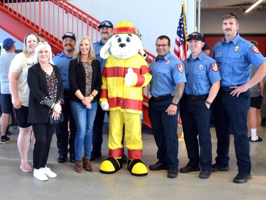 Newcastle Chamber of Commerce officials join with Sparky the Fire Dog and Newcastle firefighters to commemorate the grand opening and ribbon cutting on Fire Station #1.