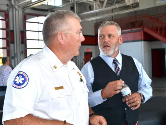 Newcastle Fire Chief Todd Yates talks with Mike McDaniel of Oklahoma Fire Pipes &amp; Drums of OKC. • photo by Mark Codner