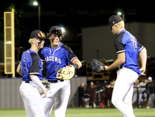 Lane Seaton, Jackson Schanuel, and Tyler Frazier meet at the pitching mound during the State Baseball Tournament. • photo by Lisa Smith-Longman