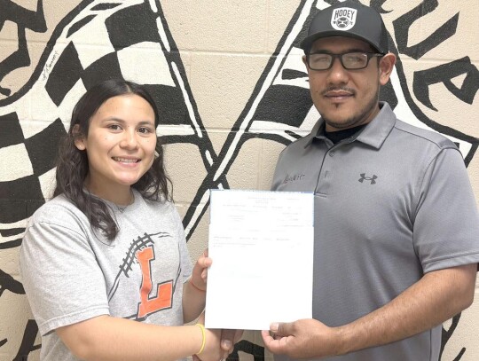 AuraValenzuelaisbeingawardedherscholarship check from Mid-America Technology Center Automotive Service Technician teacher Alex Juardo. • photo provided