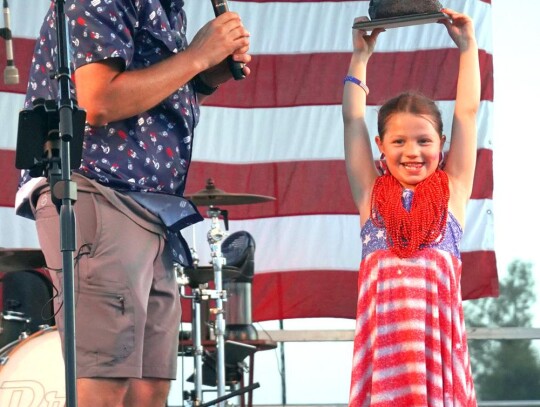 • photo by Scott Hannan City of Newcastle Parks &amp; Recreation Director Kyle Marks congratulates Sutton VanCuren for winning the Rock, Paper, Scissors challenge during this year’s Red, White &amp; Blue Fest 2024.