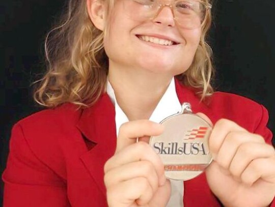 Dusti Grossnicklaus shows off the silver medal she received in the Extemporaneous Speaking contest at SkillsUSA.